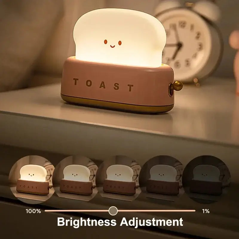 Soft pink and white silicone night light shaped like smiling toast with toast engraving for maker night light use