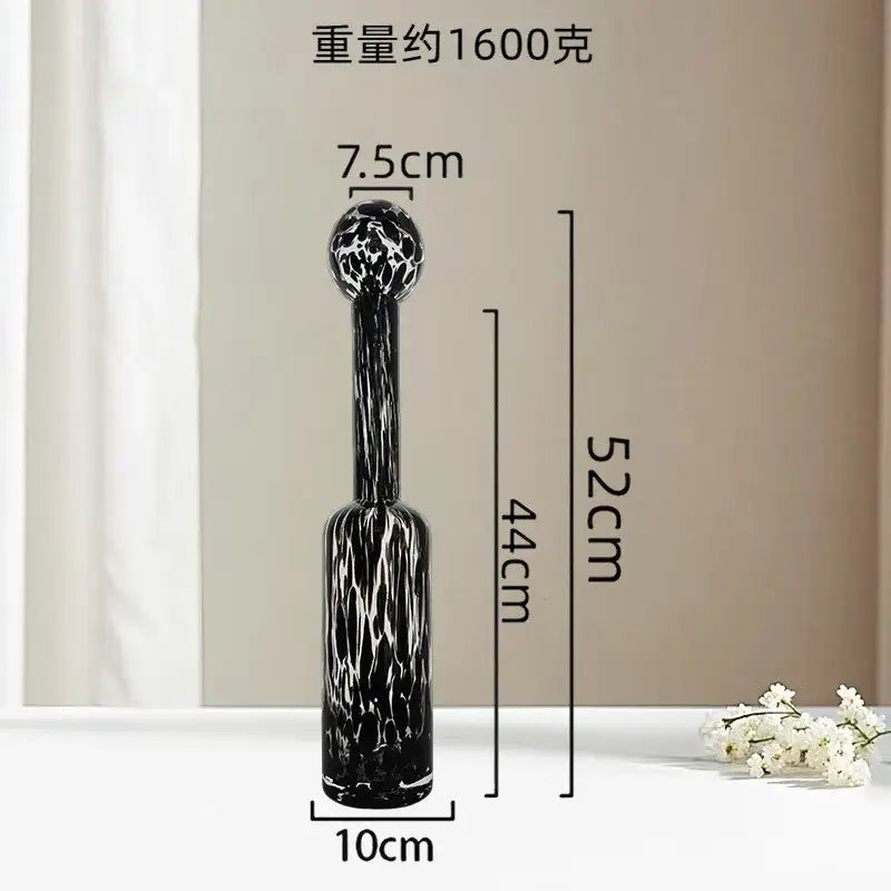 A tall slender black glass vase with textured white swirling pattern and rounded top for decorbites leopard print glass decor