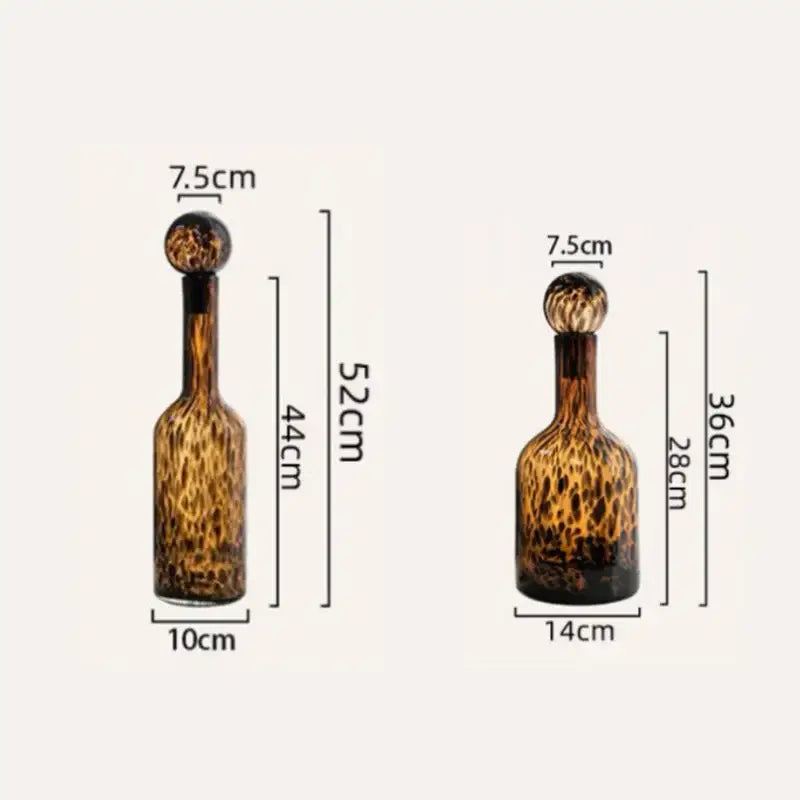 Two amber glass decanters with leopard print glass and spherical stoppers for decorbites leopard print living room decor