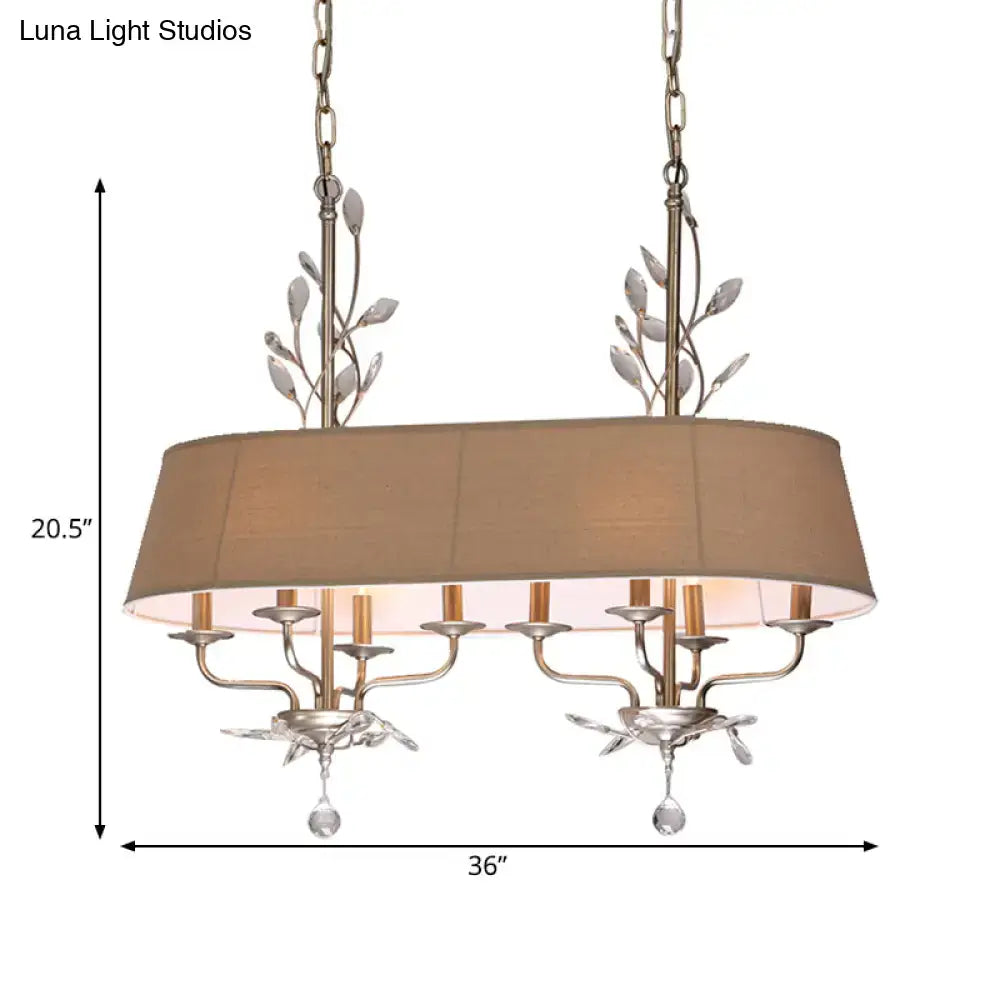 Traditional beige fabric crystal chandelier with silver metal leaf accents for dining room island lighting