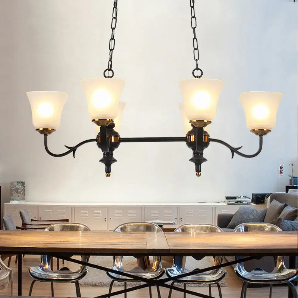 Traditional black and gold pendant ceiling lamp with white glass shades and wrought iron in dining room setting