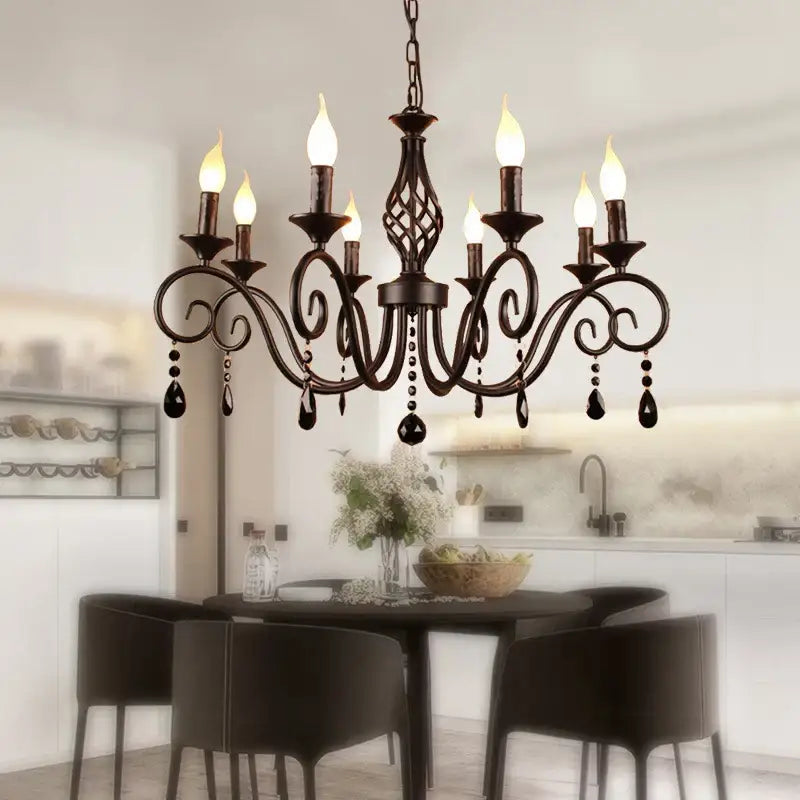 Traditional black crystal pendant chandelier featuring antique bronze wrought iron scrollwork and dangling black teardrop crystals