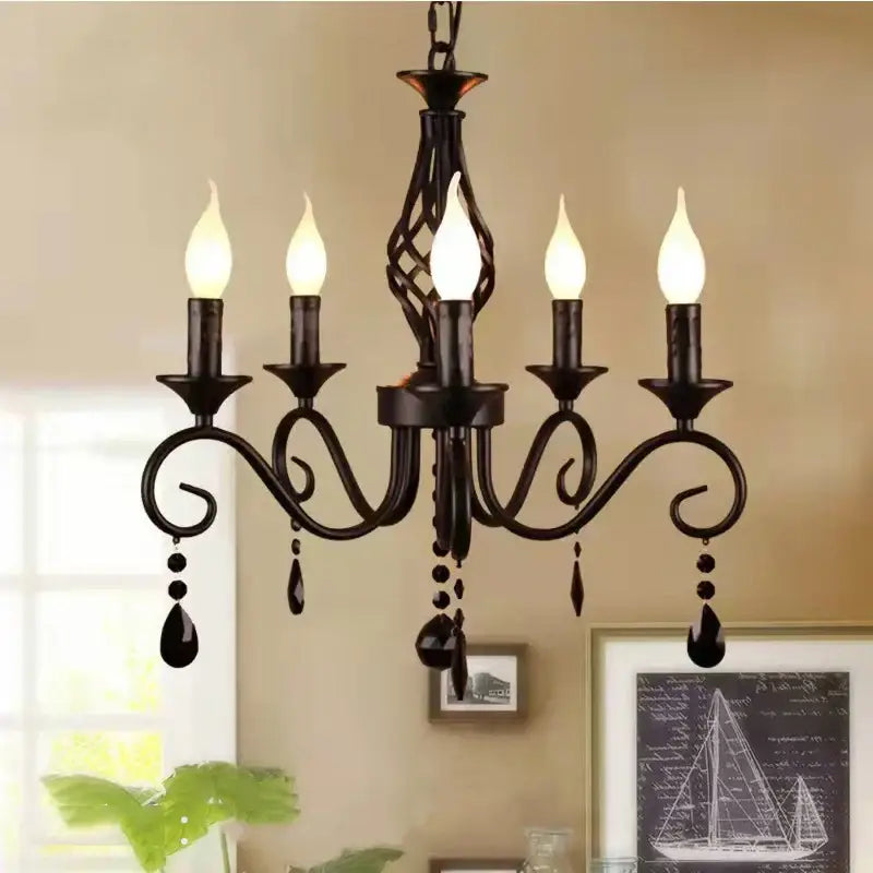 Traditional black wrought iron pendant chandelier with five candle-style bulbs and decorbites crystal pendant accents