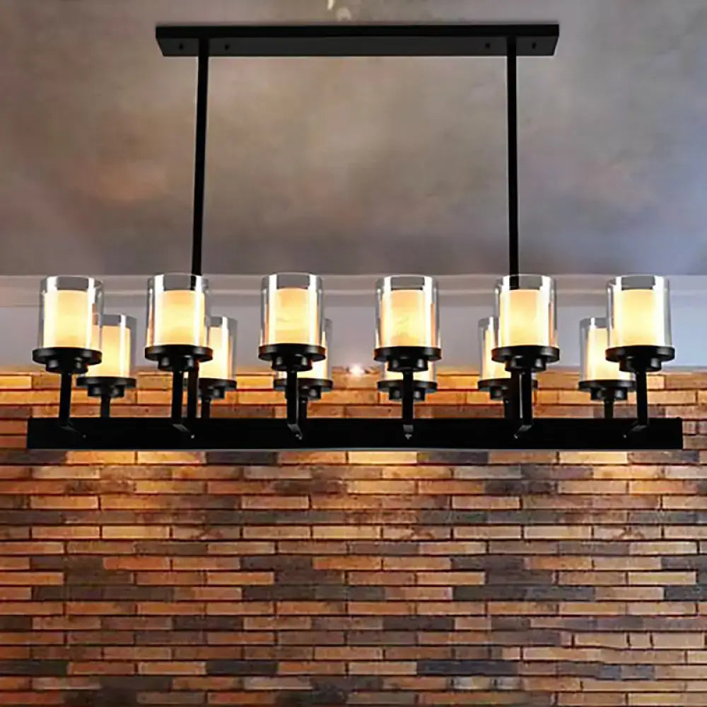 Traditional black cylinder black metal chandelier with six clear glass candle-style shades emitting warm light