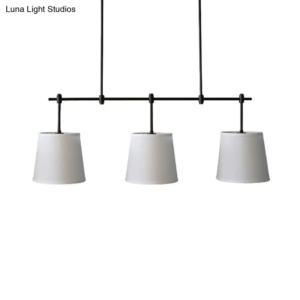 Traditional black metal pendant lighting with three white fabric shades for dining room or lights barrel island use