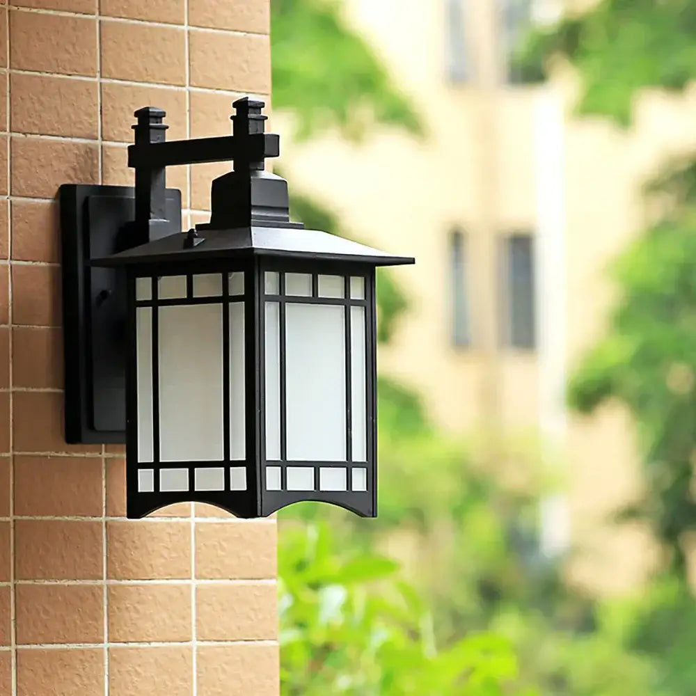 Traditional black led wall lamp garden lantern made of wrought iron with frosted glass and ornate design for outdoor use
