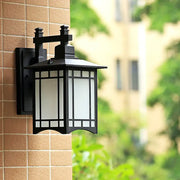 Traditional black led wall lamp garden lantern made of wrought iron with frosted glass and ornate design for outdoor use