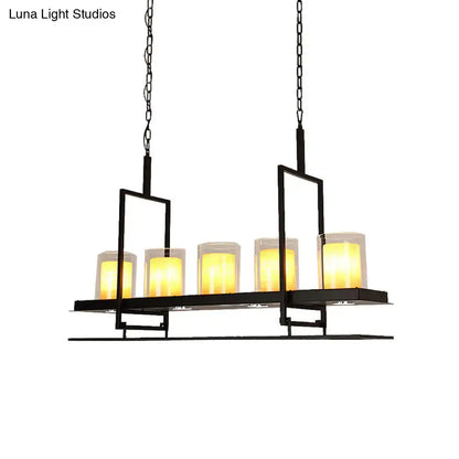 Black metal chandelier with five warm yellow candle lights in clear glass holders for heads cylinder island use