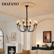 Traditional black metal chandelier with nine lit candle-style heads pendant lights and decorative ceiling rose by decorbites black metal