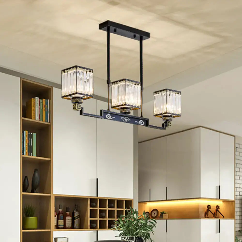Black metal DecorBites crystal island chandelier with three rectangular glass shades and decorative scrollwork