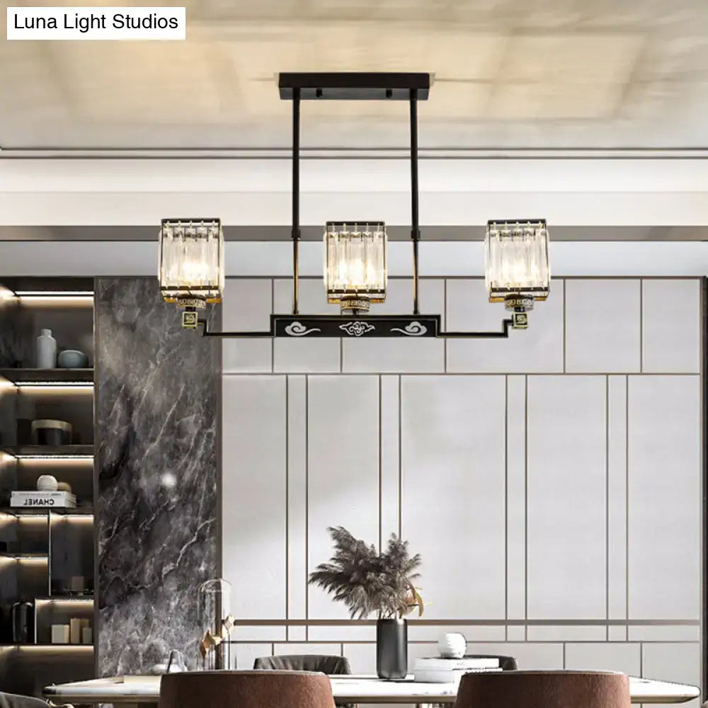 Black metal crystal island chandelier with three rectangular glass shades, gold accents, and decorative cloud motifs