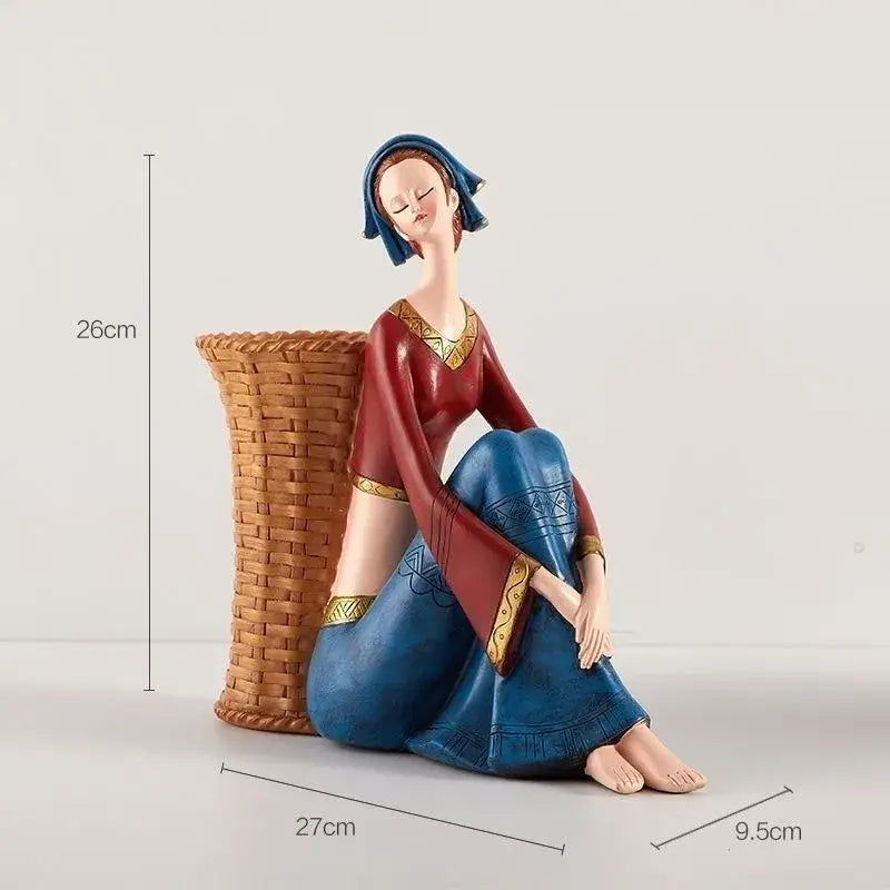 A detailed resin ornament of a woman in traditional red and blue attire for decorbites cute girls storage