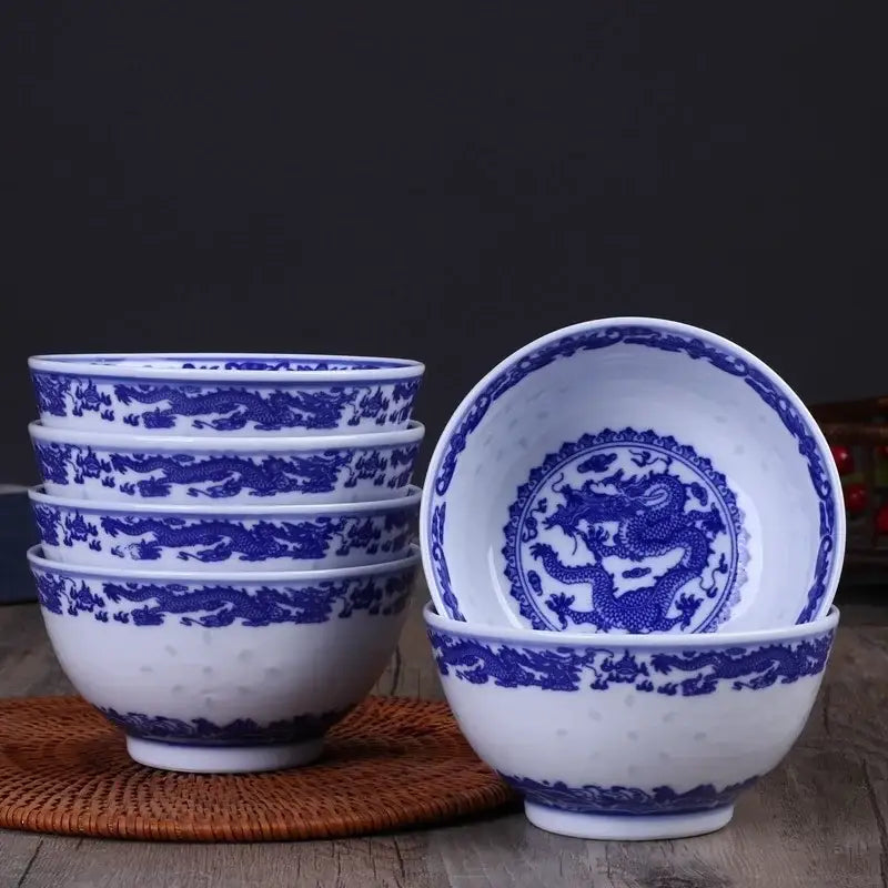 Set of five white porcelain dragon rice bowls with intricate blue designs and subtle textured surface for dining