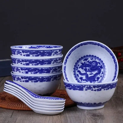 Set of six white porcelain dragon rice bowls with intricate blue dragon motifs and matching spoons for dining use