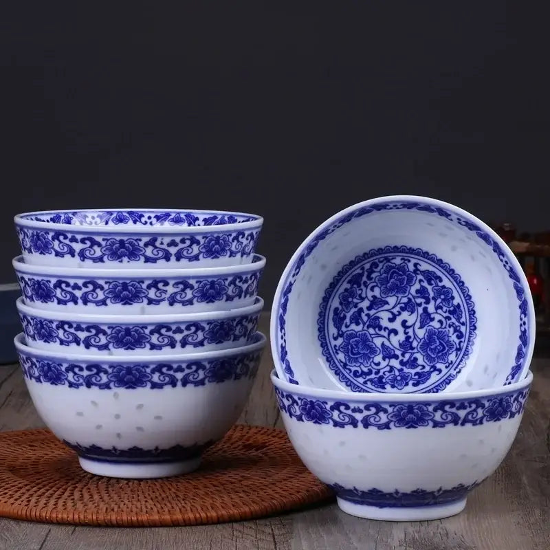 Set of five traditional blue and white porcelain dragon rice bowls with intricate floral patterns for dining use