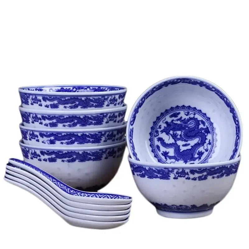 Set of six white porcelain dragon rice bowls with intricate blue dragon patterns and matching spoons for dining