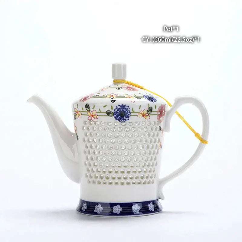 White ceramic tea pot with floral and dotted patterns and navy blue base band blue white porcelain decorbites blue white