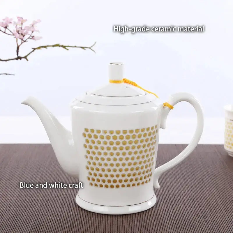 White ceramic tea pot with gold dot pattern and yellow ribbon from decorbites blue white porcelain teaware collection