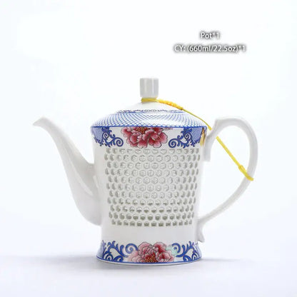A white ceramic tea pot with blue white porcelain floral design and perforated body by decorbites blue white