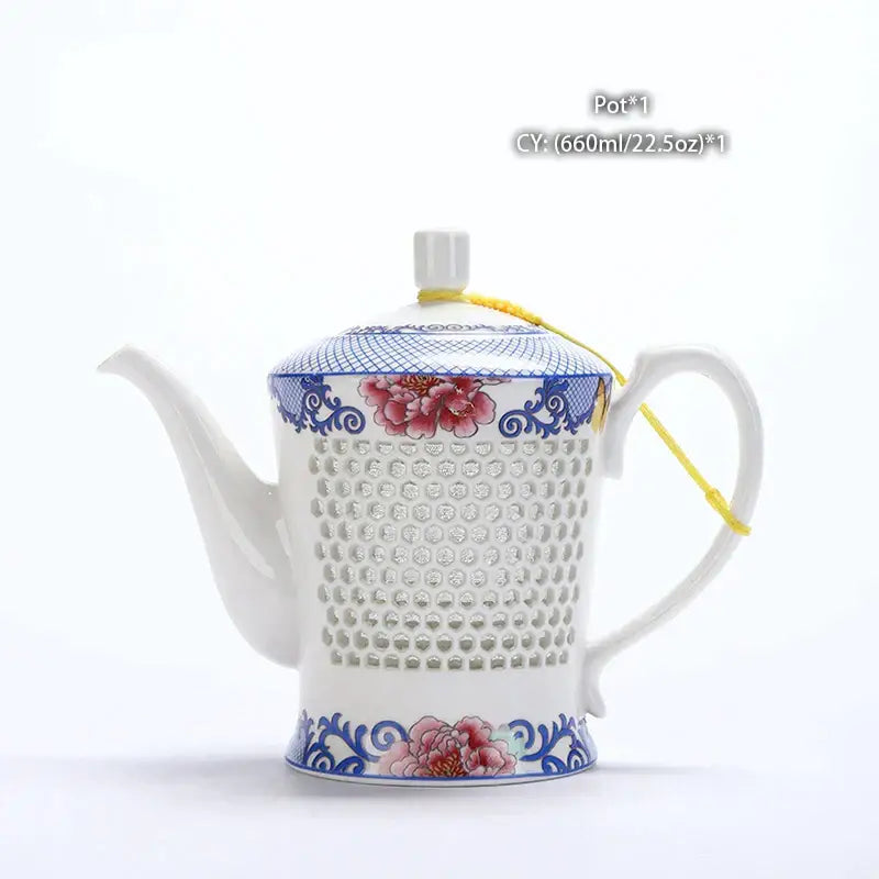 A white ceramic tea pot with blue white porcelain floral design and perforated body by decorbites blue white