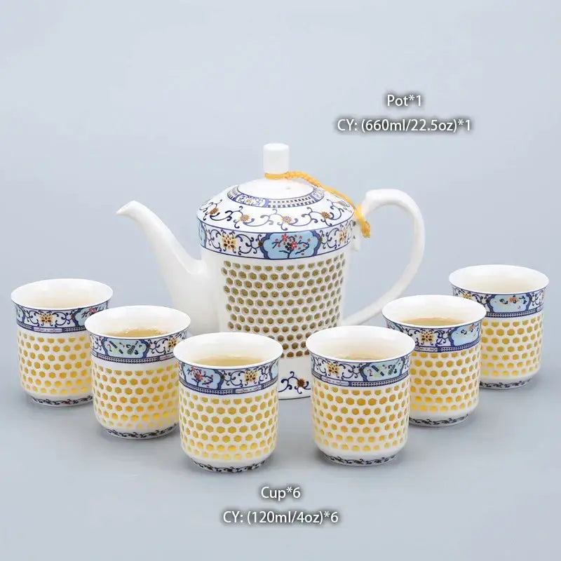 Traditional blue white porcelain tea pot with six matching cups featuring intricate blue floral patterns on yellow body