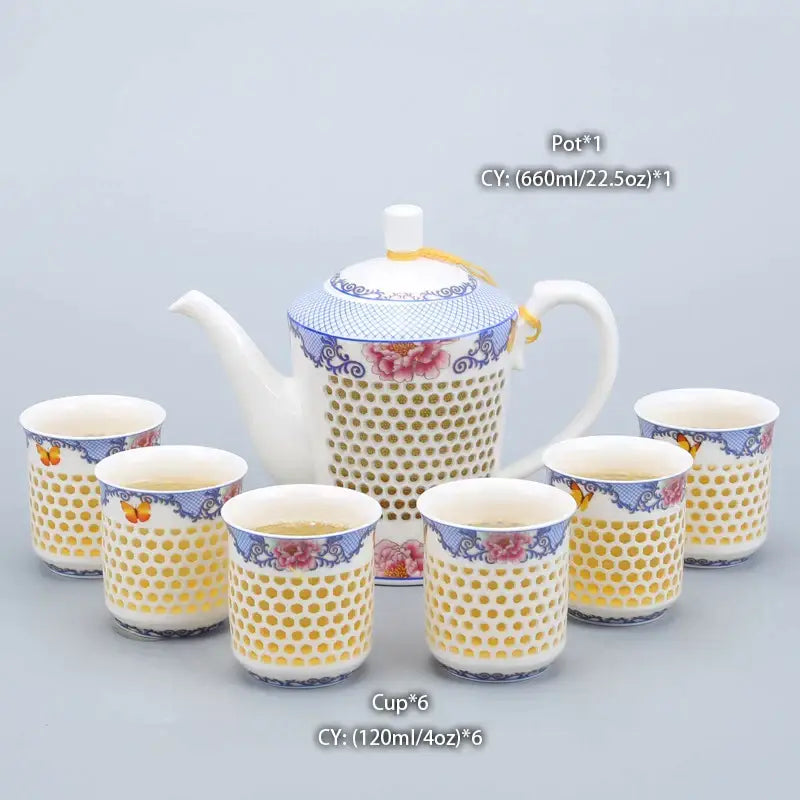 Traditional blue white porcelain tea pot and cups with blue floral gold dot patterns and perforated ceramic design by decorbites