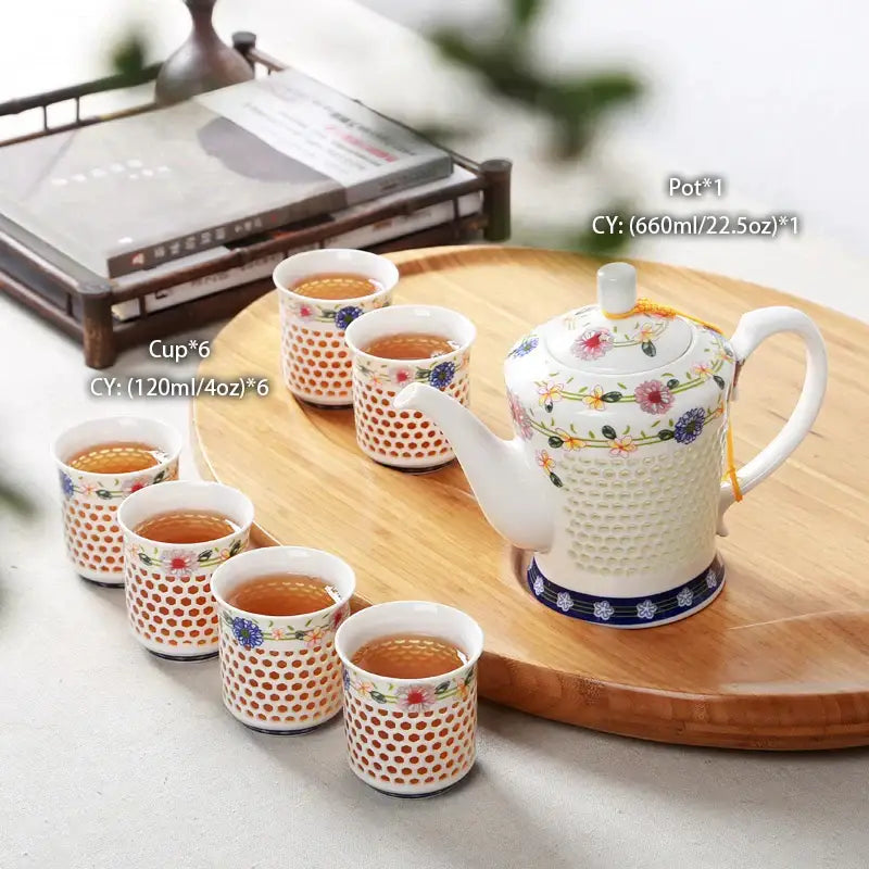 Traditional blue and white porcelain tea teapot with honeycomb texture floral patterns and blue decorative band decorbites blue white