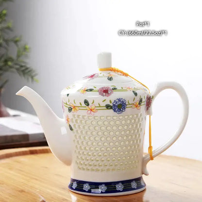 A white porcelain tea teapot with a perforated body floral pattern and yellow cord from blue white porcelain set