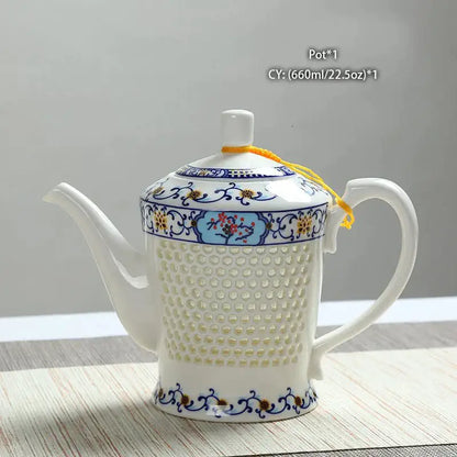 White porcelain tea teapot with blue white porcelain floral patterns perforated body and yellow cord lid decorbites blue white