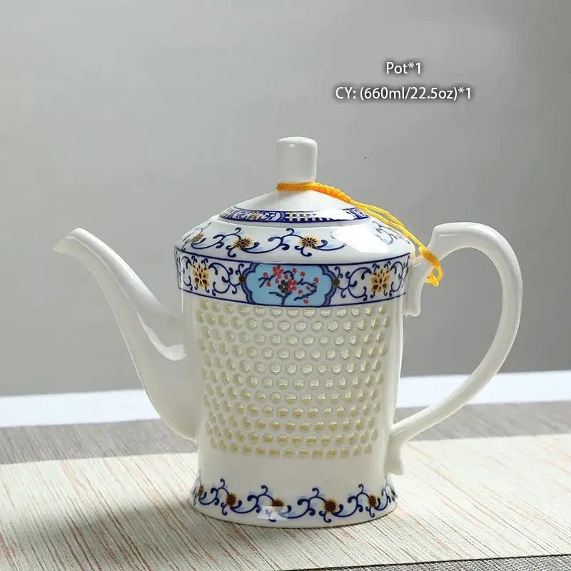 White porcelain tea teapot with blue white porcelain floral patterns perforated body and yellow cord lid decorbites blue white