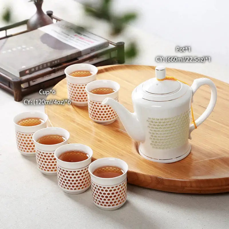 Traditional blue white porcelain tea set with white porcelain honeycomb body and gold-trimmed lid and handle decorbites blue white