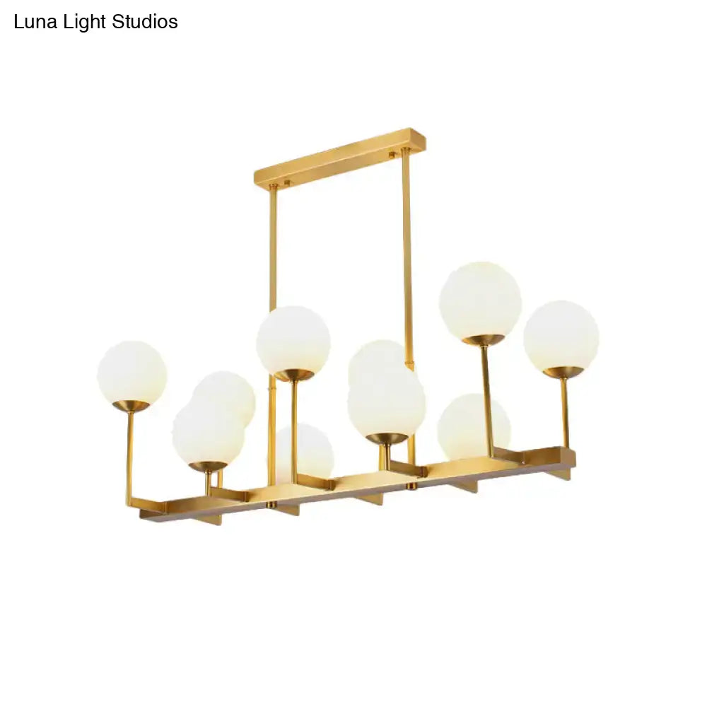 Decorbites opal glass island pendant light in traditional brass with multiple frosted globe shades for dining room