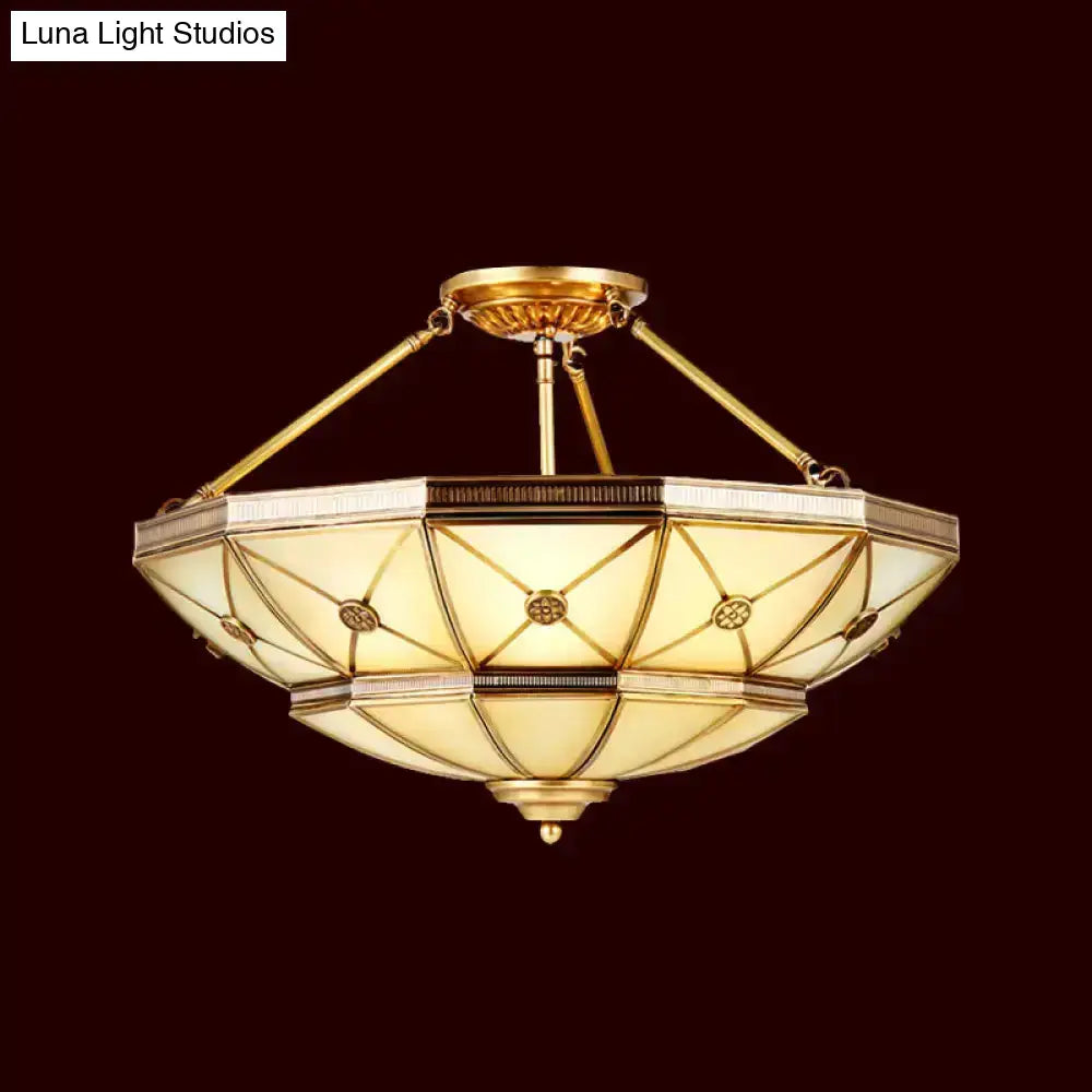 Gold-toned semi-flush mount fixture with geometric stained glass and brass accents 23.5 to 32 inch width 220v-240v