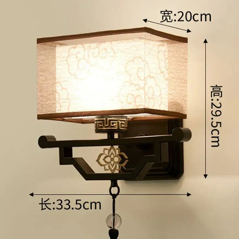 Traditional bronze floral elegant fabric wall lamp with off-white patterned shade and dark bronze frame for bedroom lighting