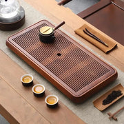 Traditional brown bamboo tea tray with rich finish and parallel grooves for water storage and dining room use