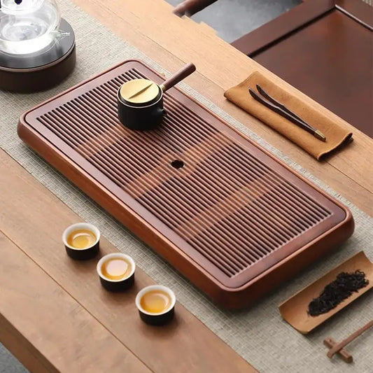 Traditional brown bamboo tea tray with rich finish and parallel grooves for water storage and dining room use