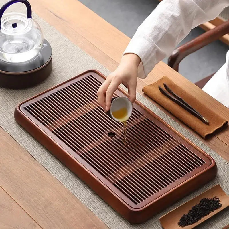 Traditional brown bamboo tea tray with water storage features a rectangular wooden design with parallel slats for drainage