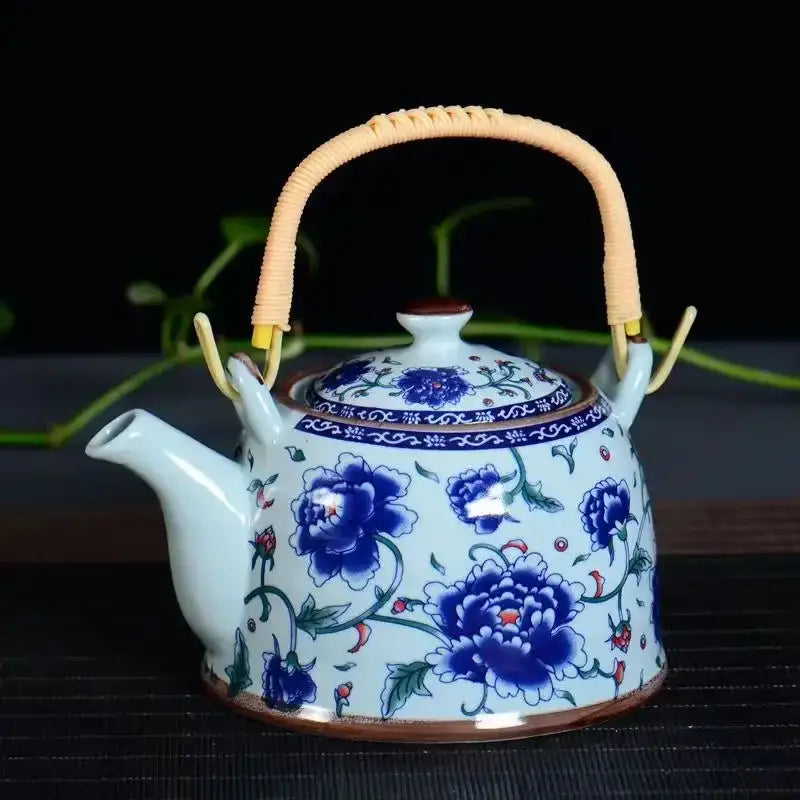 A delicate traditional chinese white porcelain tea pot with light blue glaze and cobalt blue peony decor for dining room