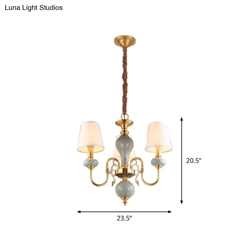 Traditional gold and blue chandelier with ceramic orbs and fabric shades for elegant dining room lighting