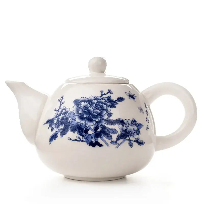 A classic white porcelain dehua clay teapot with blue floral and insect motifs from decorbites dehua clay tea set