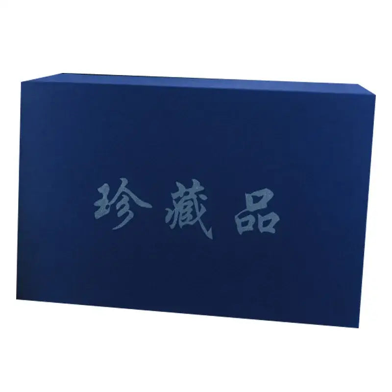 Deep blue rectangular box with embossed chinese characters contains traditional ivory eight immortals sculpture wood decor for living room