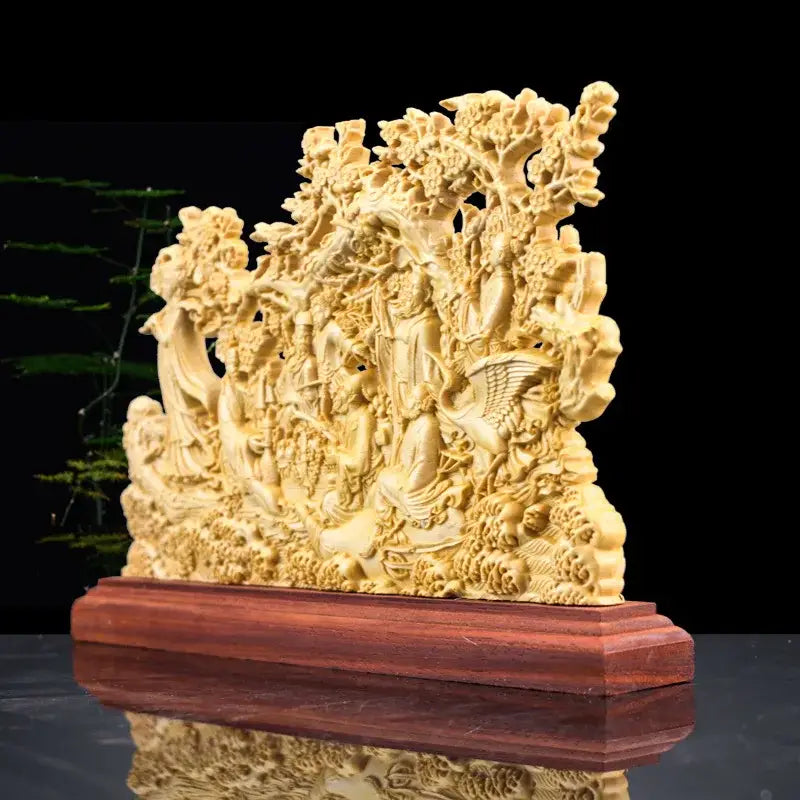 Elaborately carved light golden wood eight immortals sculpture with detailed figures and foliage on reddish-brown base