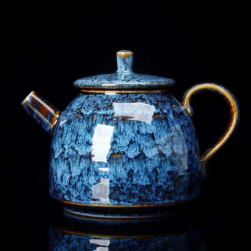 A glossy blue ceramic tea pot with speckled glaze and gold-toned handle from decorbites ceramic kung fu tea set