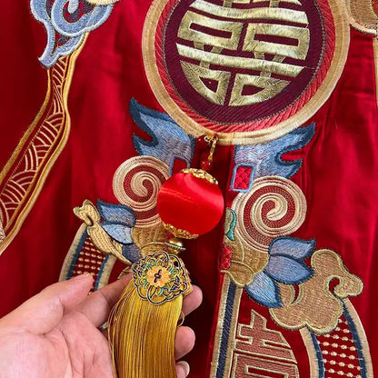 A vibrant red tassel ornament with gold metallic base and embroidered floral details for luxury gold loong bedding set decor
