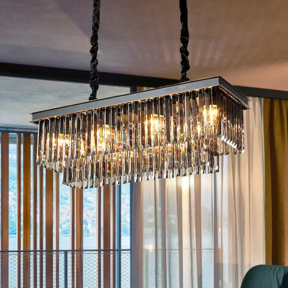 Rectangular smoke gray crystal light fixture with sleek chrome frame and black twisted cords for dining room