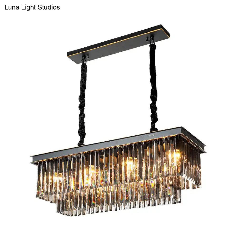 Rectangular light fixture with black metal frame and smoke gray crystal prisms for dining room illumination