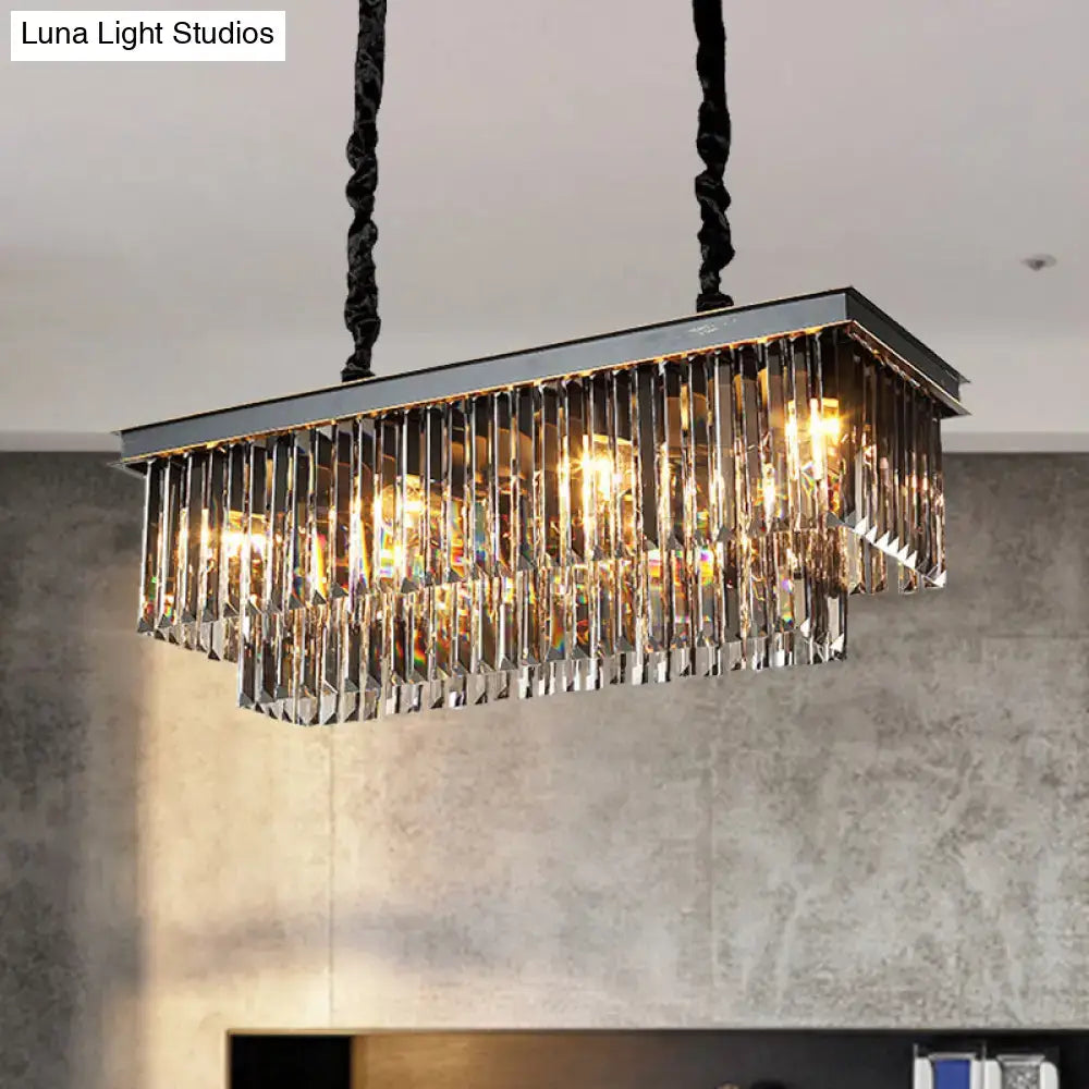 Rectangular light fixture with smoke gray crystal blocks and black twisted cords for dining room use