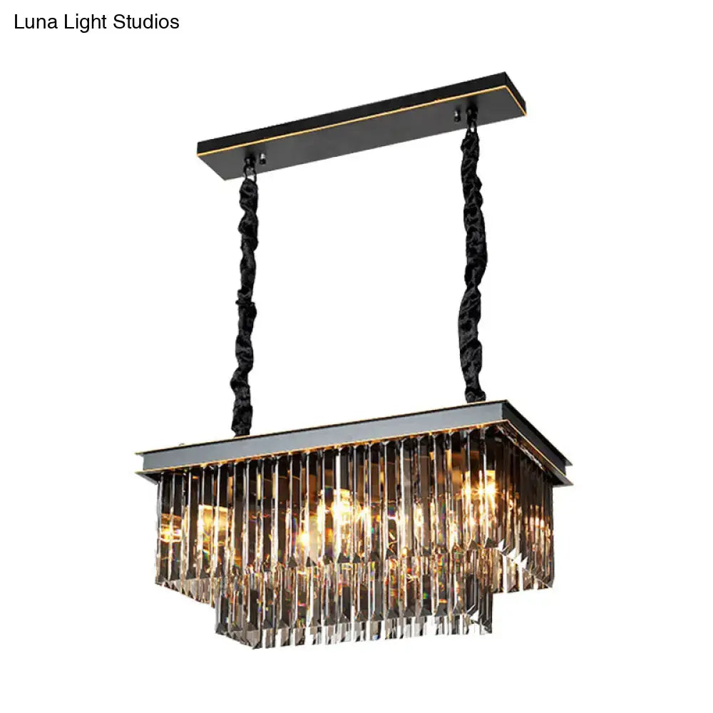 Black and gold rectangular light fixture with cascading smoke gray crystal prisms for dining room use