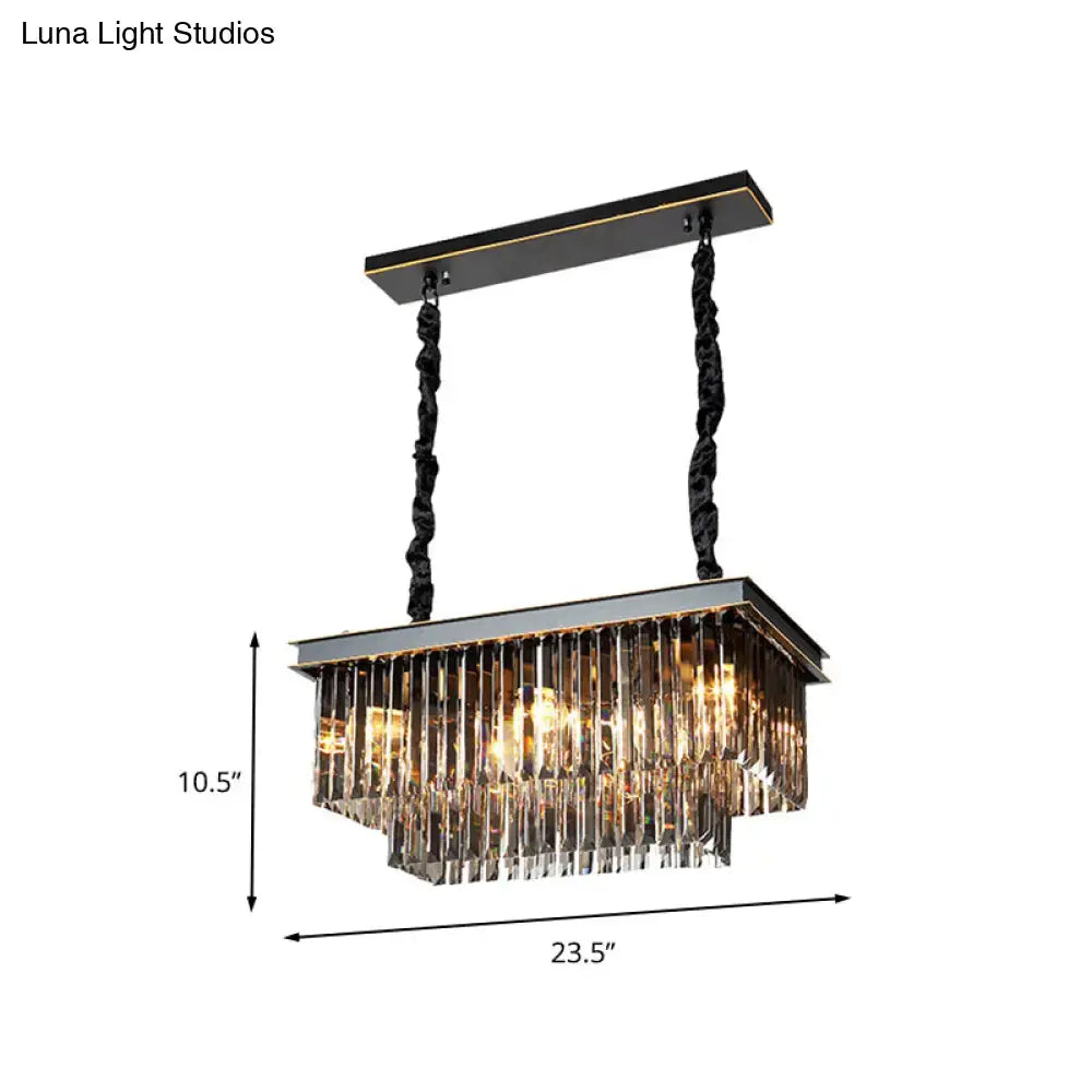 Black and gold rectangular light fixture with cascading clear crystal prisms for a traditional smoke gray dining room
