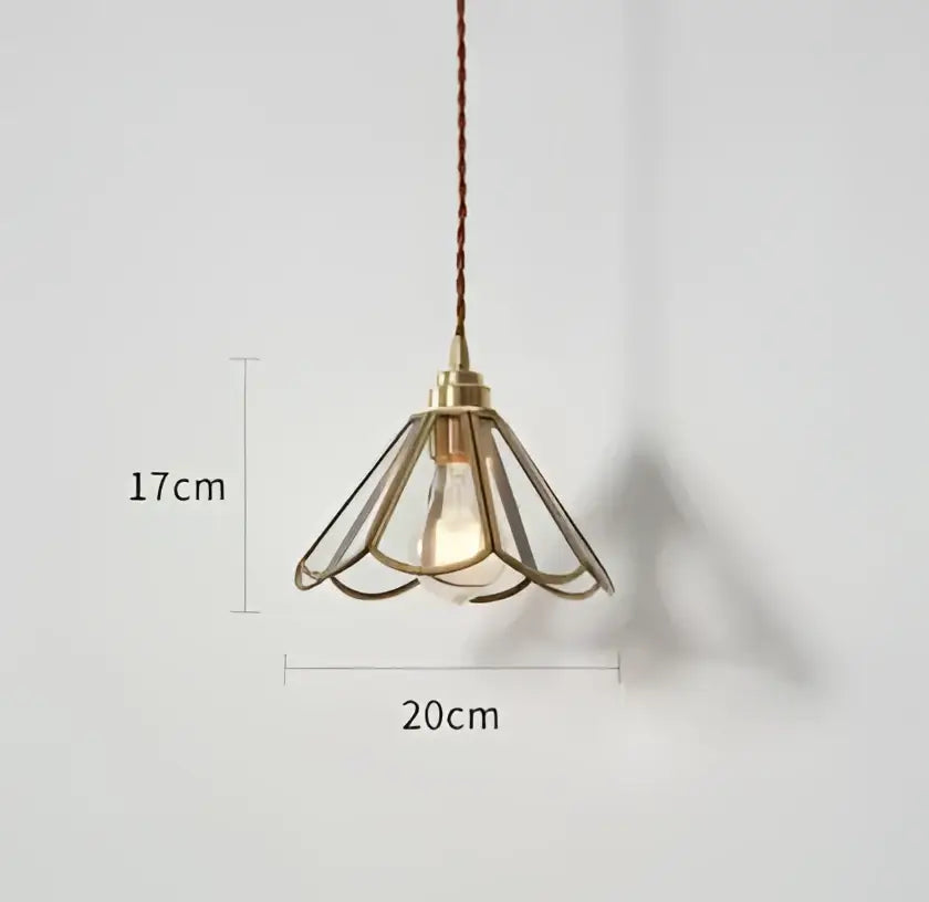 A brass-colored cage-style pendant light with warm glow and exposed bulb complementing decorbites blue glass pendant